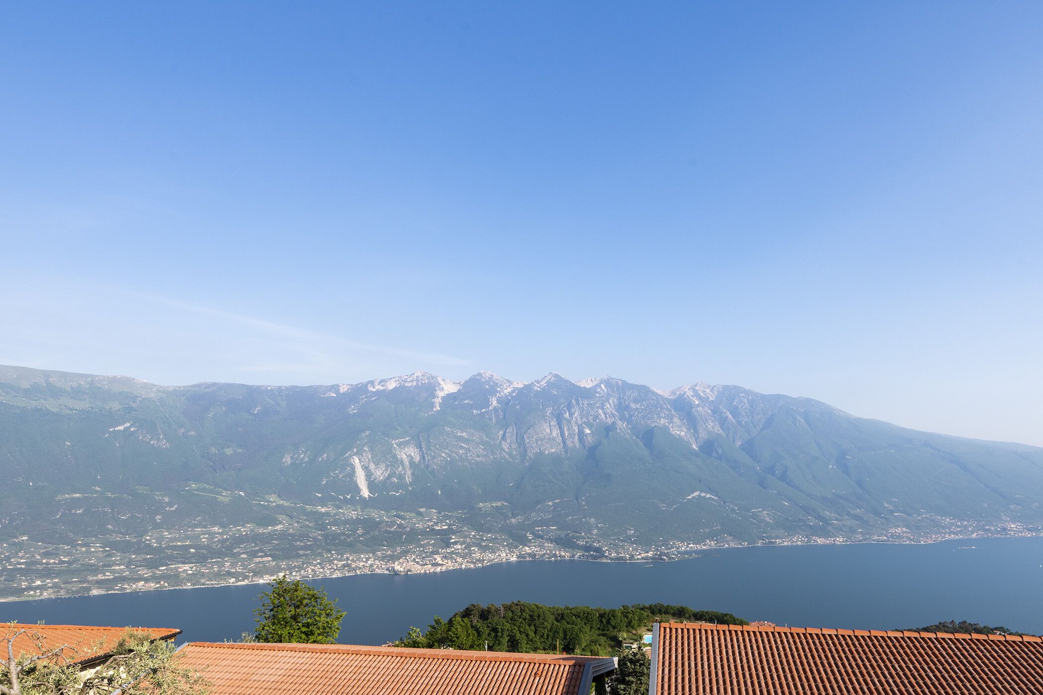 A mountainous landscape with a lake and a town in the valley.