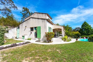 A house with a white exterior, green shutters, and a swimming pool in the backyard. - VILLA ROCHE GRISE VI3010 by RIVIERA HOLIDAY HOMES (Berre-les-Alpes)