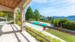 A pool with a wooden pergola, a stone pathway, and a view of green trees and mountains. - VILLA ROCHE GRISE VI3010 by RIVIERA HOLIDAY HOMES (Berre-les-Alpes)