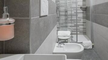 Ein modernes Badezimmer mit Badewanne, Toilette und Waschbecken.