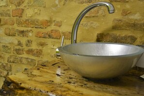 A metal bowl sink against a brick wall. - B&B La Lanterna (Fermo)