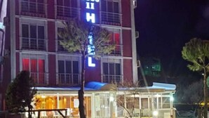 A hotel with a prominent red sign reading "BOSS II HOTEL" and a smaller sign below it. - Boss II Hotel (Eceabat)