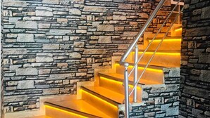 A staircase with a stone wall backdrop and illuminated steps. - Boss II Hotel (Eceabat)