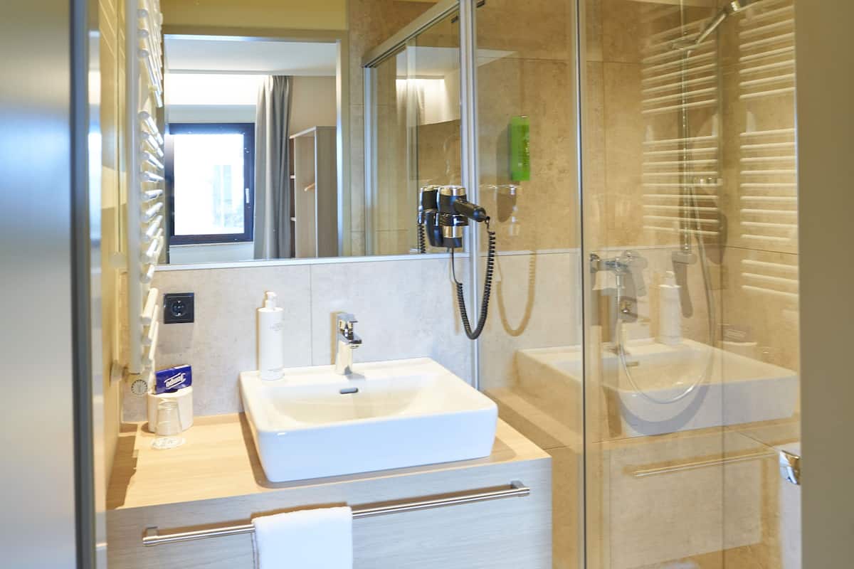 superior double room | bathroom | shower, free toiletries, hair dryer, towels