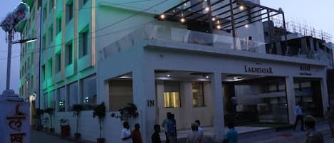 A hotel with a modern facade, a prominent entrance, and a visible restaurant named "Manan".