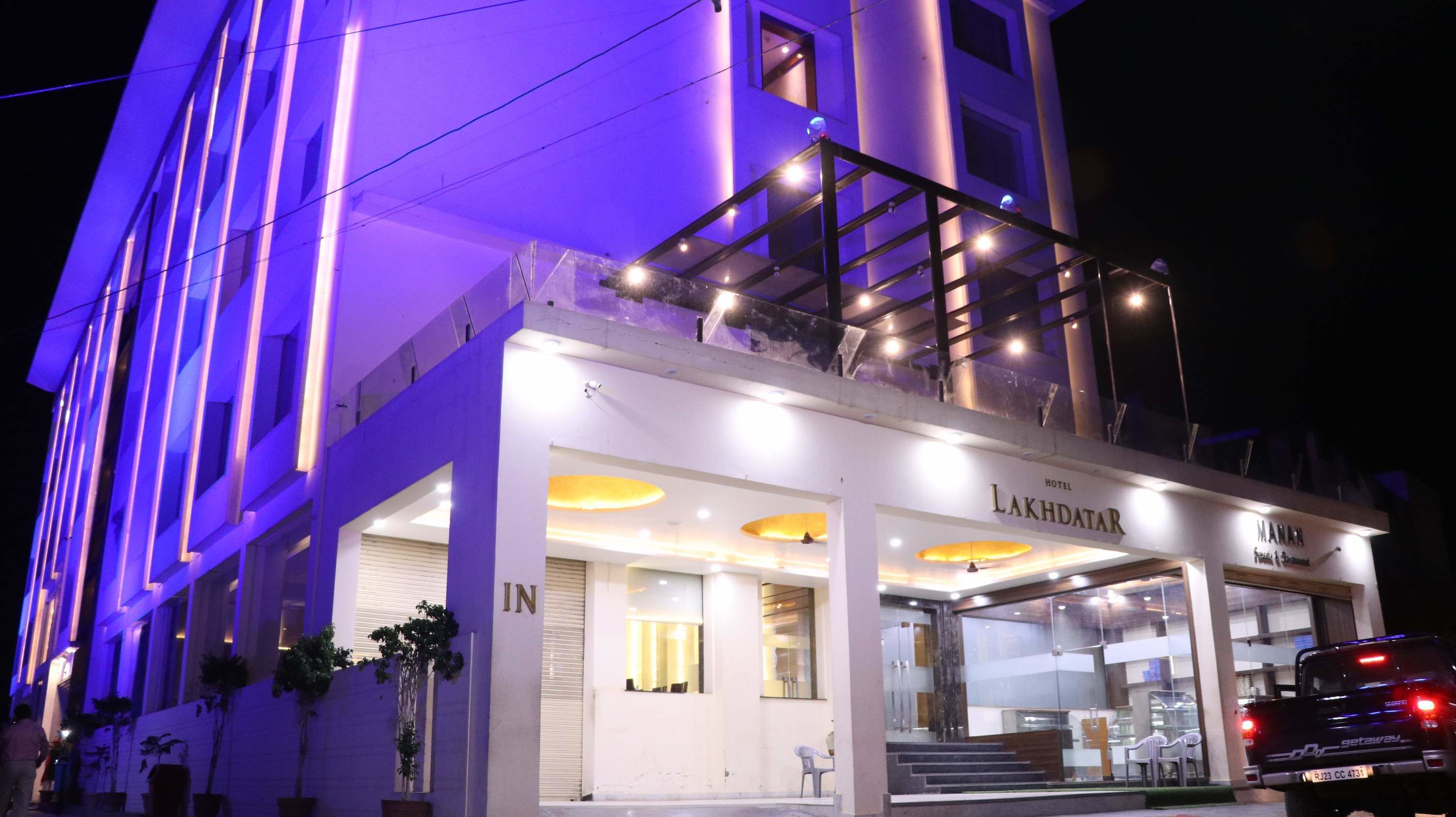 A hotel with a modern facade, a visible entrance, and a staircase leading to the upper level.