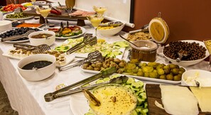 A buffet table with various food items and utensils. - Atropat Hotel Baku (Baku)
