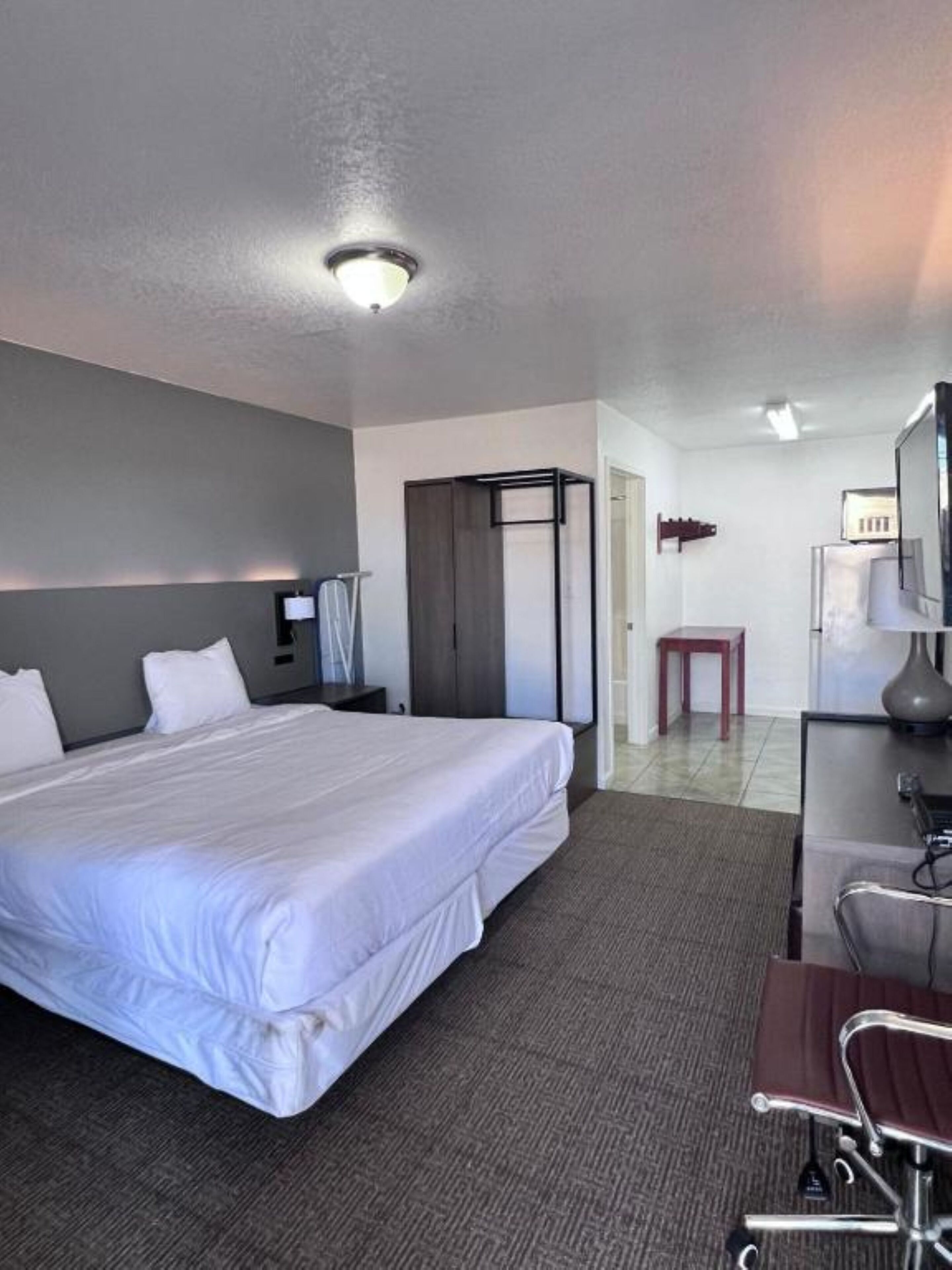 Premium Room, 1 King Bed, Kitchenette | Desk, iron/ironing board (on request), WiFi (free), bed sheets