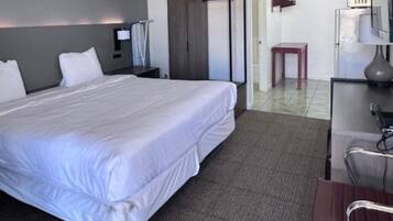 Premium Room, 1 King Bed, Kitchenette | Desk, iron/ironing board (on request), WiFi (free), bed sheets