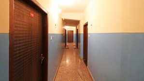 A hallway with doors marked 110 and 111, leading to rooms. - OYO 4979 Prabha Palace Lodge (Guwahati)