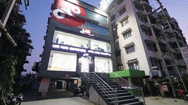 A multi-story building with a large sign for a hotel. - OYO 4979 Prabha Palace Lodge (Guwahati)