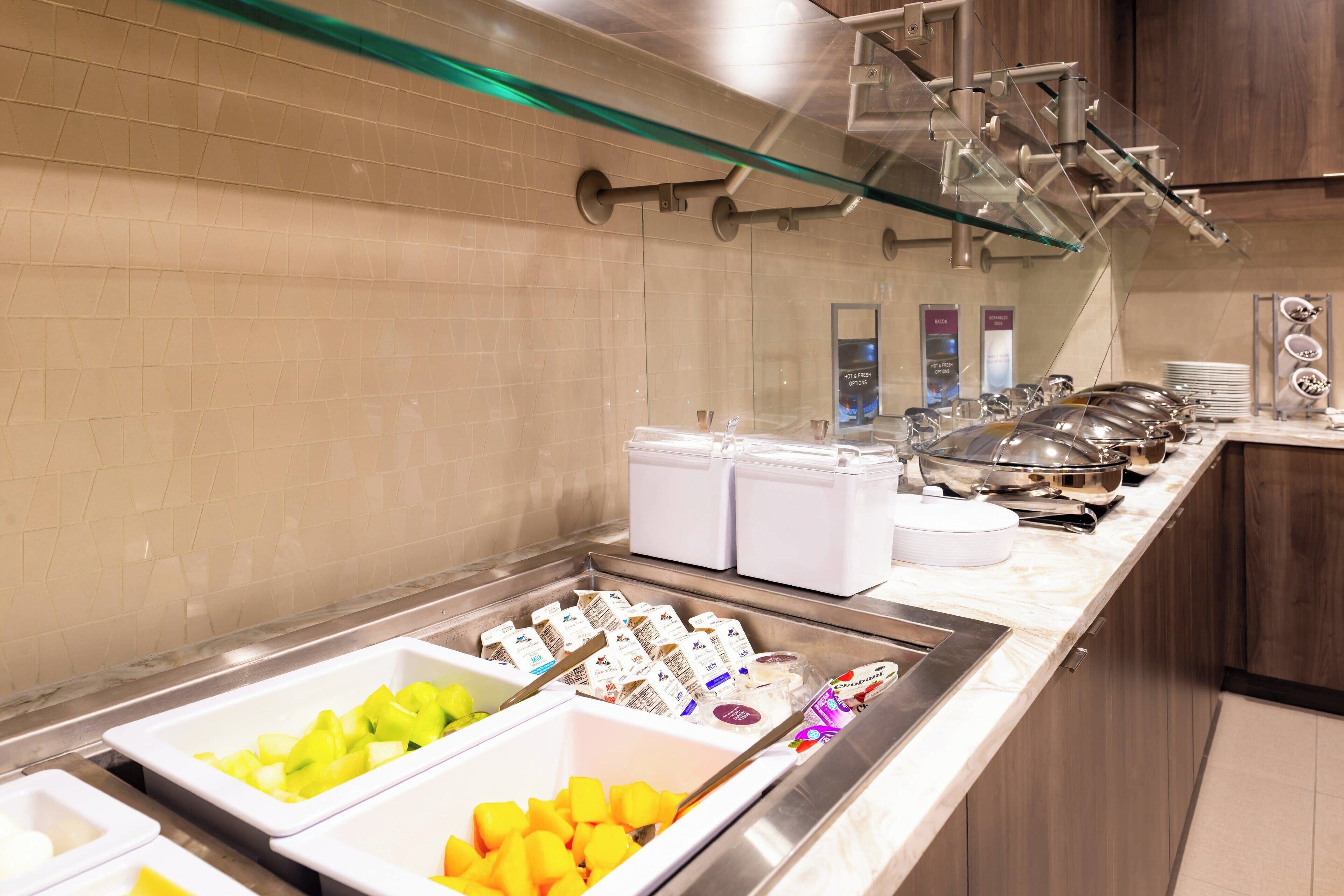 A buffet area with various food items and containers.