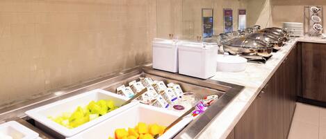 A buffet area with various food items and containers.