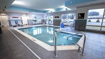 Ein Hallenbad mit Lifter, Liegestühlen und einem Schild mit der Aufschrift 'Nicht tauchen'.