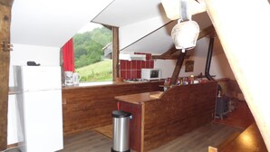 A modern kitchen with wooden countertops, a white refrigerator, and a red tiled backsplash. - Gites des Pics: the Black Pic - panoramic view (Riverenert)
