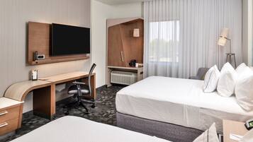 Premium bedding, desk, laptop workspace, blackout drapes