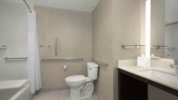 A modern bathroom with a toilet, shower, and sink.