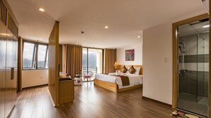 A modern hotel room with a large bed, a glass shower, and a balcony with a view. - BEAUTIFUL SAPA HOTEL (Sa Pa)