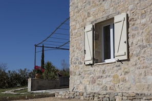 A stone building with a window and a clothesline.