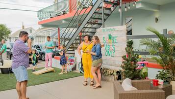 An outdoor area with a sign that reads "The Storehouse" and "SHORE VIBES ONLY".