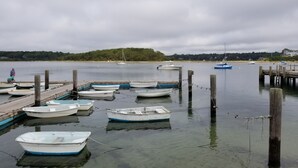 A calm harbor with several small boats docked at wooden piers. - Charming Cape House in Megansett area of North Falmouth - walk to the beach! (North Falmouth)