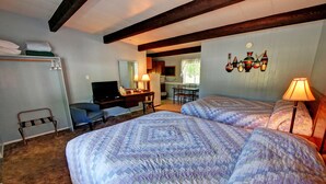 A bedroom with two beds, a desk, a chair, a television, and a dining area. - Idle A While (Twisp)