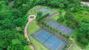 An aerial view of a park with multiple tennis courts, a walking path, and surrounding greenery. - Reserva do Sahy, Condado (Mangaratiba)