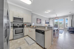 Enjoy cooking in this well-equipped kitchen with a microwave, oven, and dishwasher.