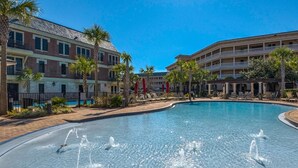 A hotel with a swimming pool, palm trees, and a multi-story building. - Overlooking 30A!  Great Location! Easy Beach & Pool Access! (Seacrest Beach)