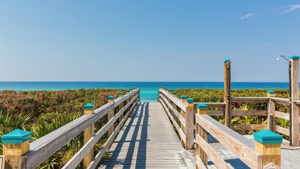 A wooden boardwalk leading to a beach with a clear view of the ocean. - Overlooking 30A!  Great Location! Easy Beach & Pool Access! (Seacrest Beach)