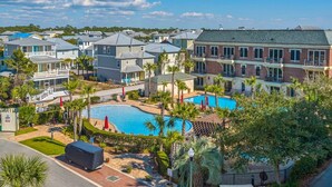 A residential area with a swimming pool surrounded by houses and palm trees. - Overlooking 30A!  Great Location! Easy Beach & Pool Access! (Seacrest Beach)