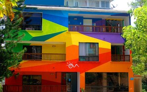 A multi-story building with balconies and large windows. - Hotel On Vacation Magic Hill (San Andrés)