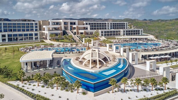 A resort with multiple swimming pools, a central circular water feature, and a modern building complex. - Mayia Exclusive Resort & Spa - Adults Only - All Inclusive (Rhodes)