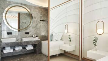 Un baño moderno con tocador doble, bañera y espejo grande con marco dorado.