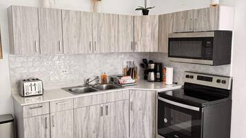 Fridge, microwave, stovetop, coffee/tea maker