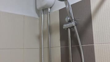 A shower with a handheld showerhead and a handheld water pump.