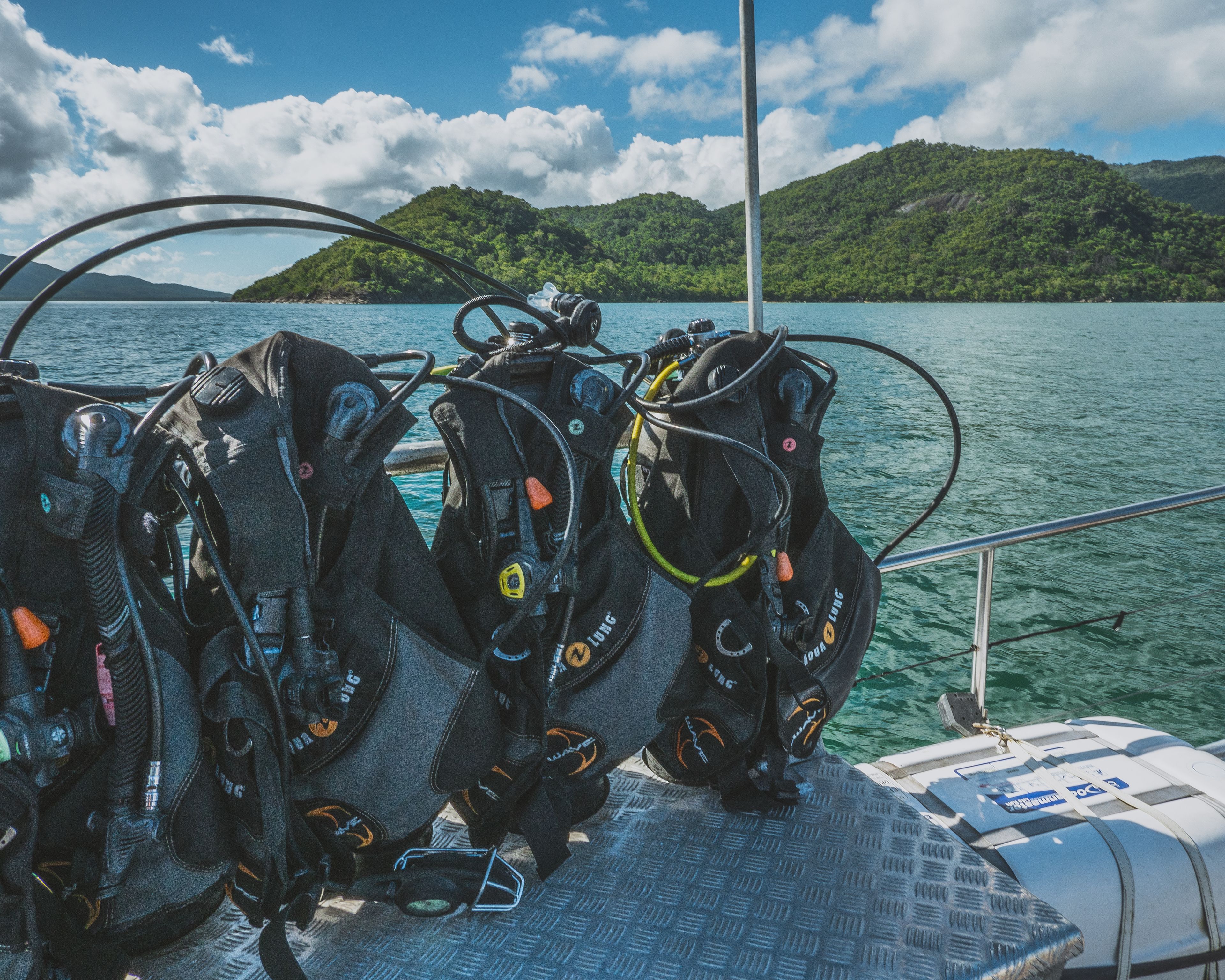 A boat with scuba diving gear and a metal railing.