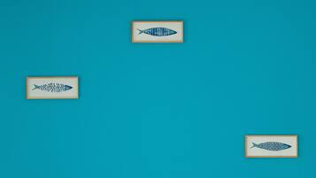 Three framed fish patterns on a teal background.