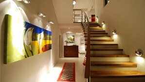 A staircase with wooden steps and a handrail, leading to an upper floor. - Selkirk House (Hermanus)