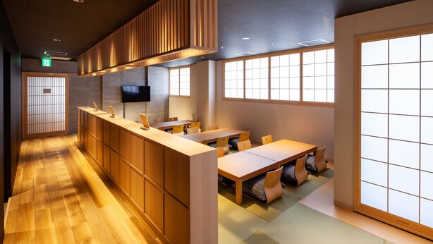 A traditional Japanese-style restaurant interior with wooden flooring, tatami mats, and sliding doors. - Y's Cabin & Hotel Naha Kokusai Dori (Naha)