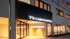Y's Cabin & Hotel with a modern facade, large glass entrance, and a well-lit interior. - Y's Cabin & Hotel Naha Kokusai Dori (Naha)