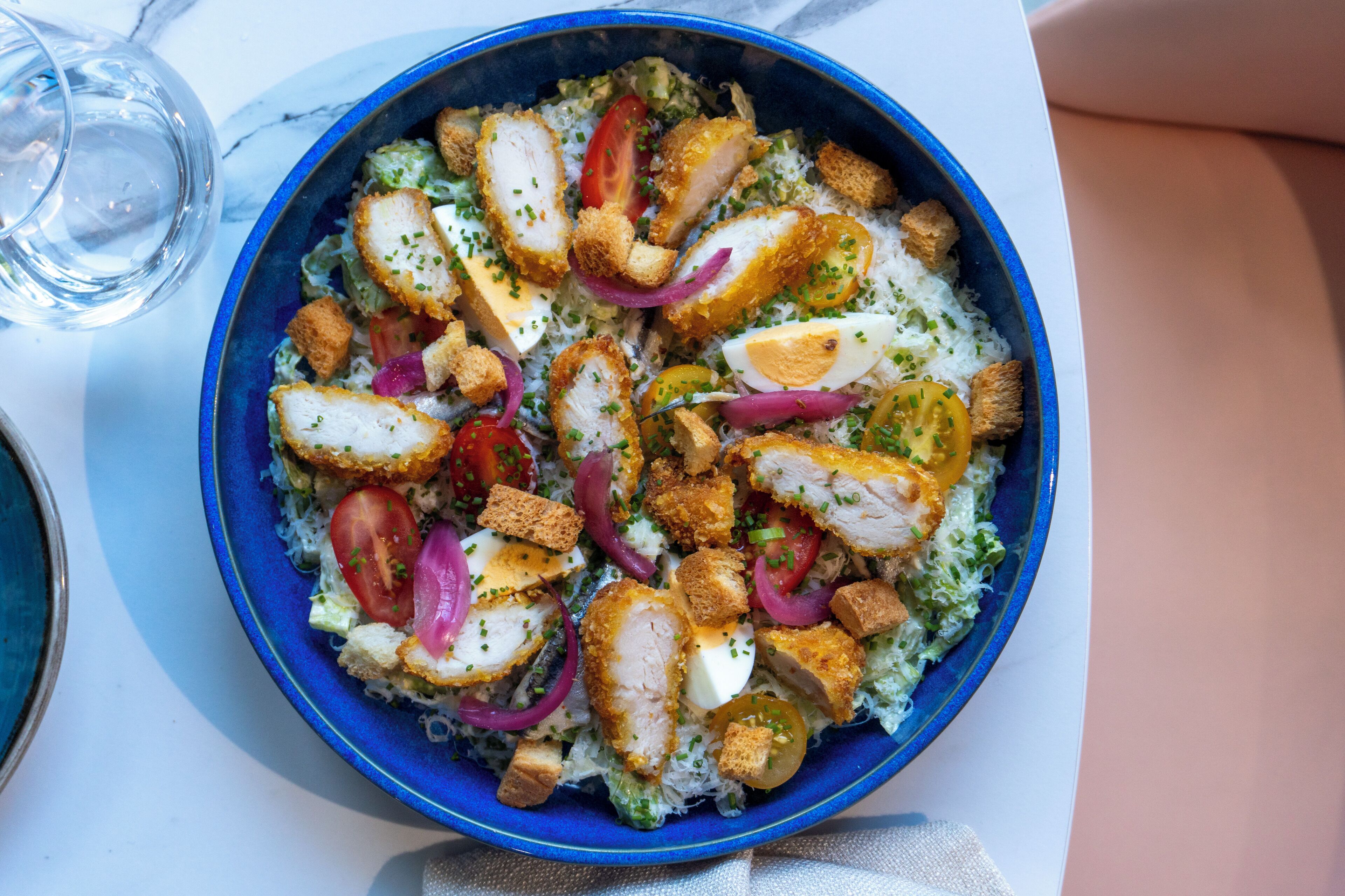 A bowl of salad with various ingredients.