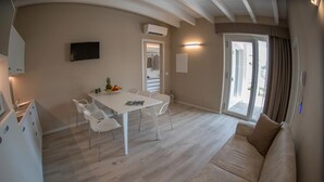 Superior Apartment, 2 Bedrooms | Living area | 32-inch flat-screen TV with satellite channels, TV - Aurora ApartHotel (Peschiera del Garda)