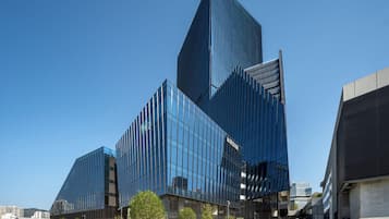 A modern building with a glass facade and the name "AIRSIDE" visible on the structure.