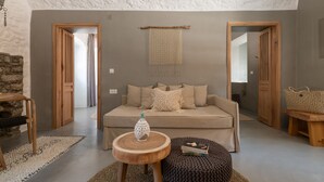 Un soggiorno accogliente con un divano, un tavolino in legno e un tappeto intrecciato.