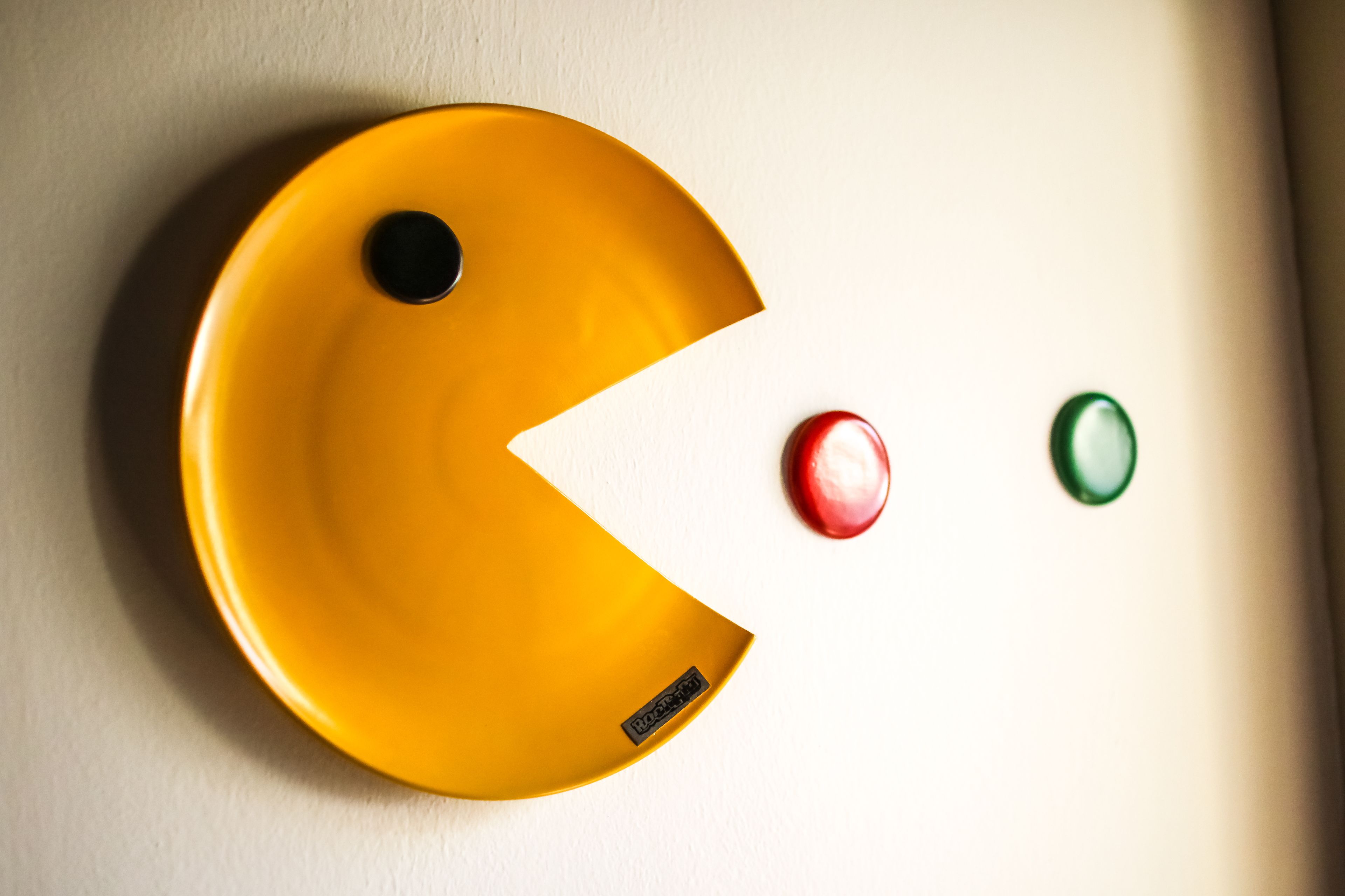 A yellow object with a black circle and a red and green circle.