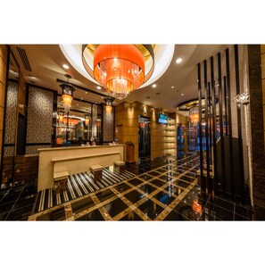 A hotel lobby with a reception desk, a large chandelier, and a check-in counter. - APA Hotel TKP Keikyu Kawasaki Ekimae (Kawasaki)