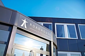 A modern building with a sign that reads "ROADHOUSE HOTEL".