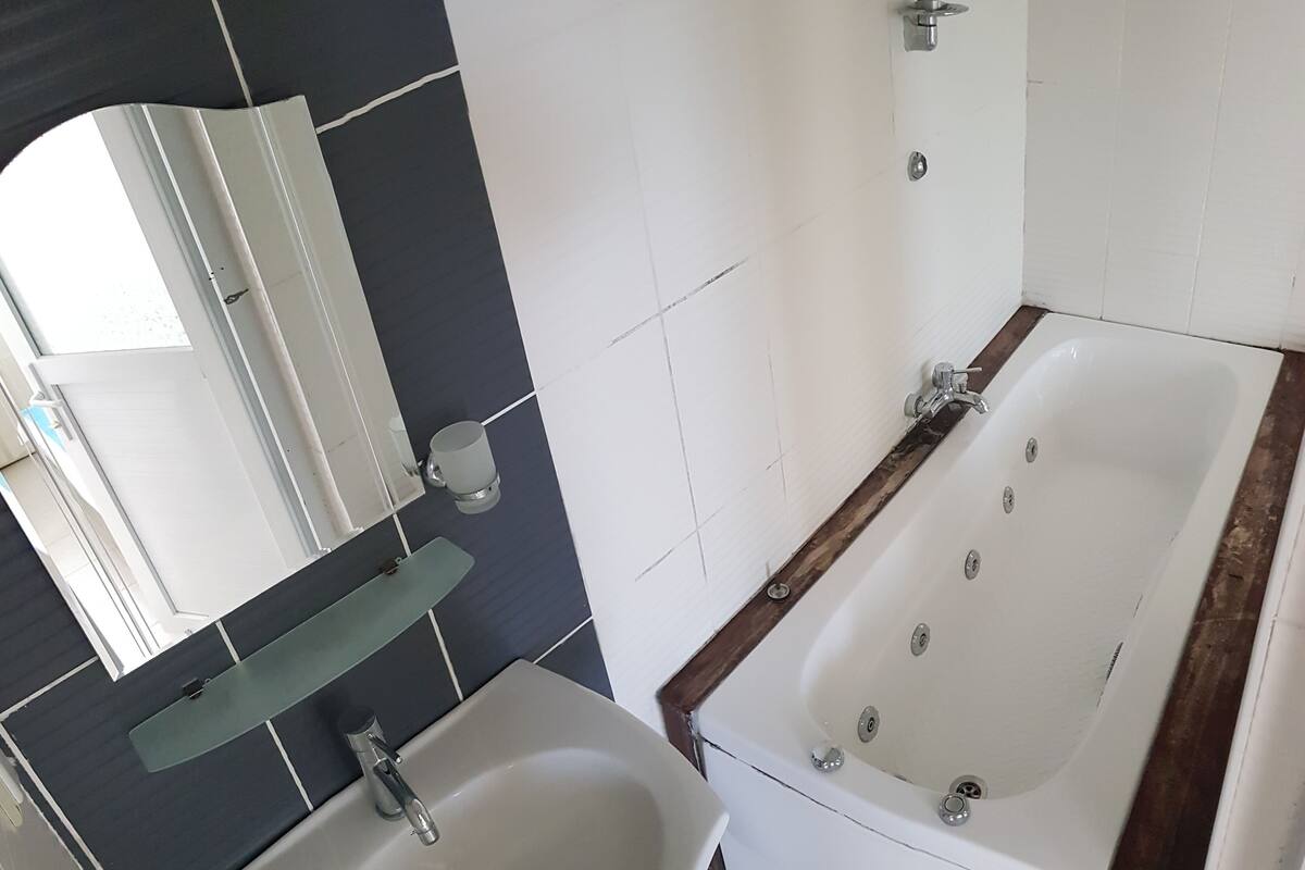 Bathroom | Shower, hair dryer, slippers, towels