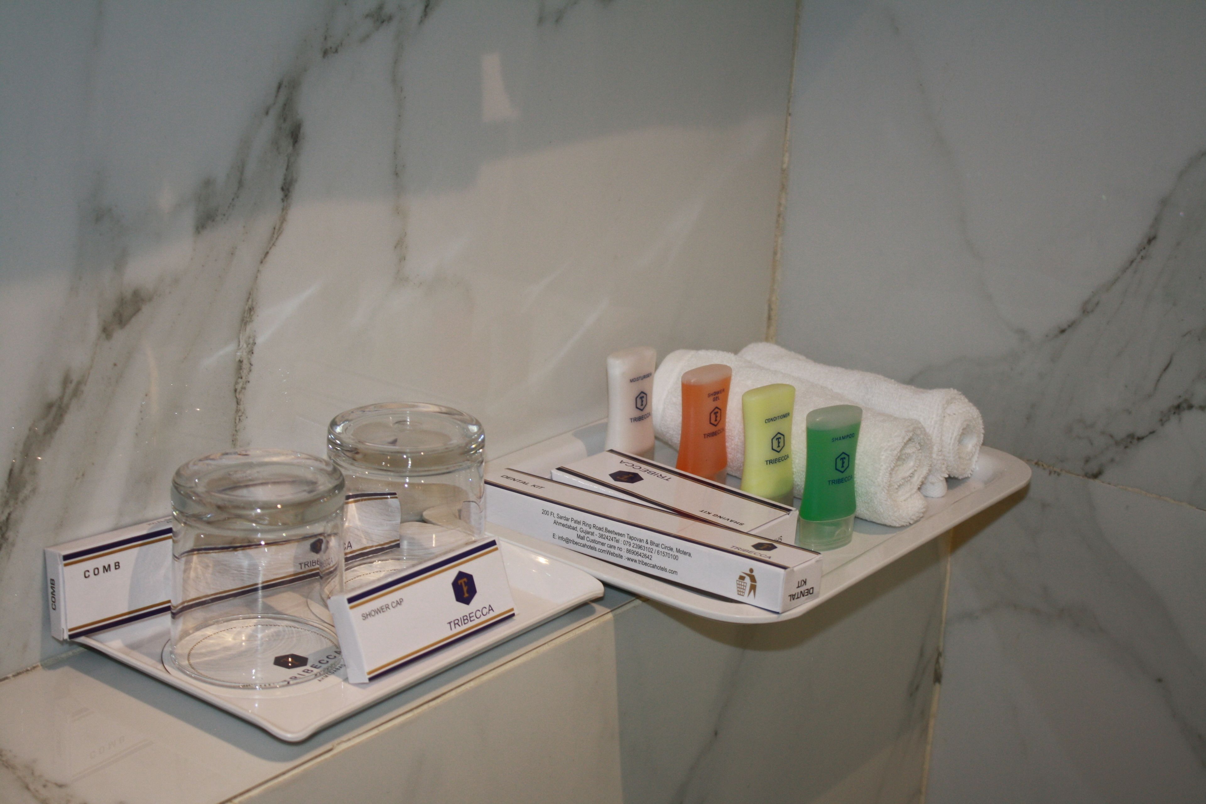 A bathroom vanity with toiletries and a shower caddy.